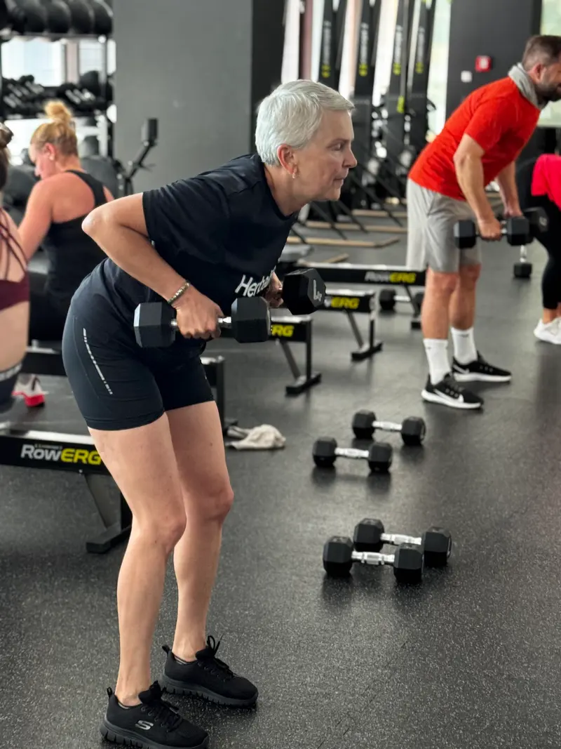 Klient při silovém cvičení s jednoručkami ve Fitness Central Park